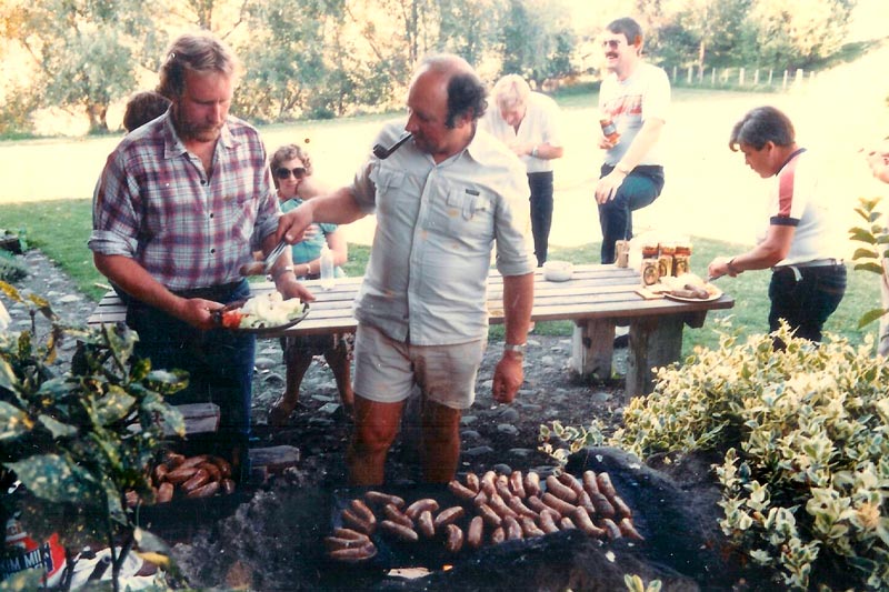 brian sage cooking some sausages after a rafting trip